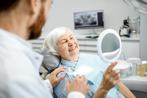 Elderly woman enjoying her new smile at Singing River Dentistry 