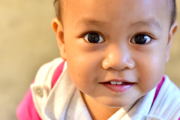 Close up image of a baby girl with teeth